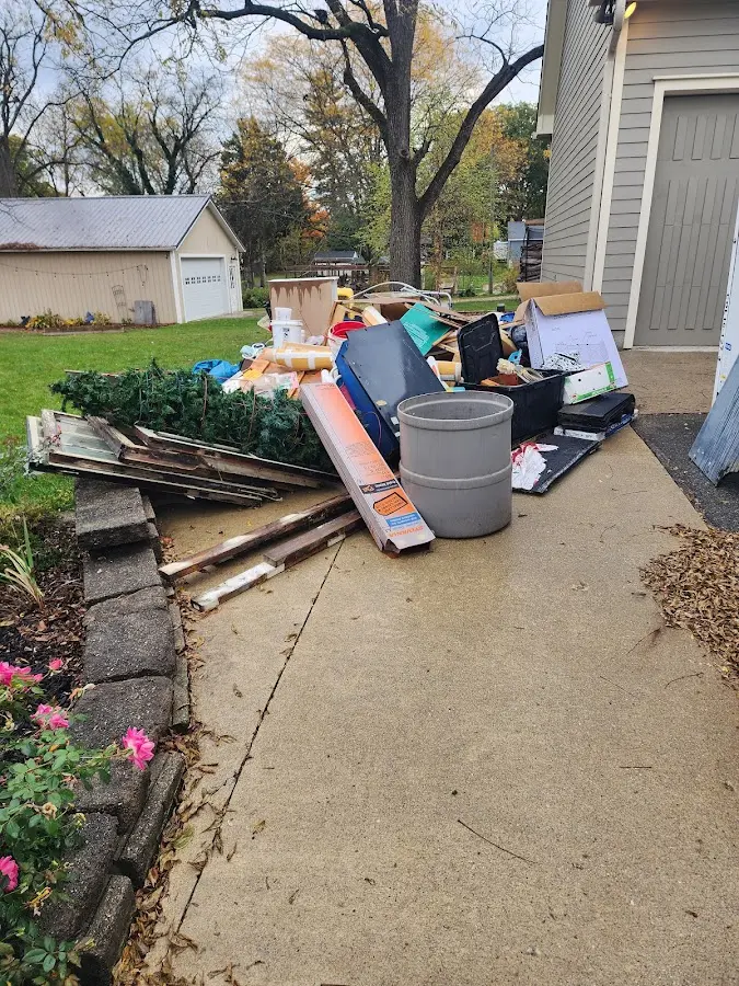 Dumpster being loaded with debris for Roofing Dumpster Rental in Story City